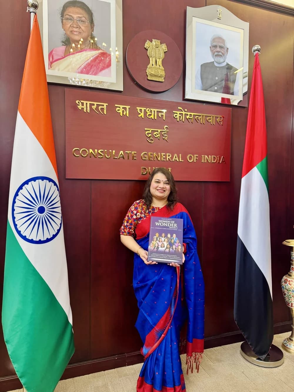 Palak Trivedi at the Indian Consulate Dubai, holding the Women of Wonder Season 2 book