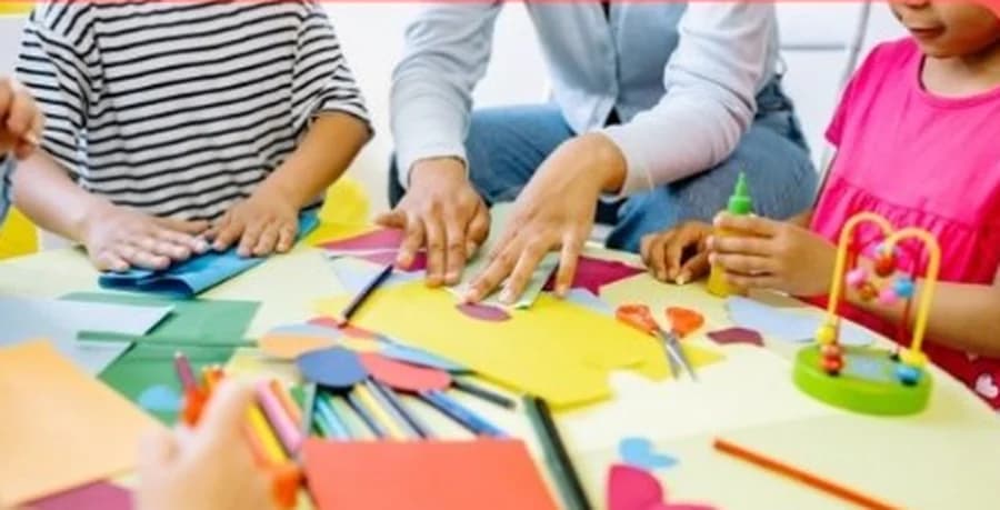 Children making art together with coloured paper and craft materials at a Zen Zone session